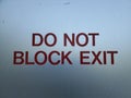 Do not block the exit sign in red letters on white background Royalty Free Stock Photo