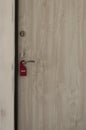 do not disturb door sign hanging at door handle
