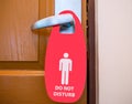 Do not disturb sign hanging on the door handle at a hotel Royalty Free Stock Photo