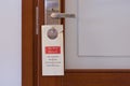 `Do not disturb` sign hanging on the door lock Royalty Free Stock Photo