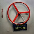 DO NOT DISTURB warning sign plate hanging on a hermetic bomb shelter armored door Royalty Free Stock Photo