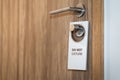 `Do not disturb` wooden plate - hanging on the door handle. Royalty Free Stock Photo