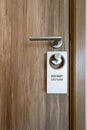 `Do not disturb` wooden plate - hanging on the door handle. Royalty Free Stock Photo