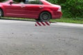 A red car drives past a warning sign on a chain Royalty Free Stock Photo