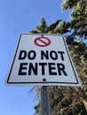 Do Not Enter Sign Post with The Blue Sky and Trees in Background Royalty Free Stock Photo