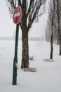 Do not enter traffic sign near the trees. Winter landscape. Baby sled near the trees