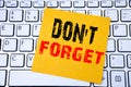 Do Not Forget. Business concept for Reminder Message written on sticky note paper on the white keyboard background. Royalty Free Stock Photo