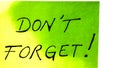 Do not forget handwriting text close up isolated on green paper with copy space. Writing text on memo post reminder