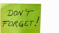 Do not forget handwriting text close up isolated on green paper with copy space. Writing text on memo post reminder