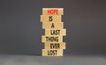 Do not lost hope symbol. Concept words Hope is a last thing ever lost on wooden blocks on a beautiful grey table grey background.
