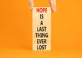 Do not lost hope symbol. Concept words Hope is a last thing ever lost on wooden blocks on a beautiful orange background.