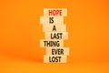Do not lost hope symbol. Concept words Hope is a last thing ever lost on wooden blocks on a beautiful orange table orange