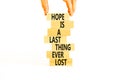 Do not lost hope symbol. Concept words Hope is a last thing ever lost on wooden blocks on a beautiful white background.