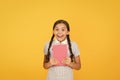 Do not panic. Hysterical laugh. Cute small child reading book on yellow background. Adorable little girl learn reading Royalty Free Stock Photo