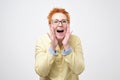 Do not tell anyone concept. Talkative prettyeuropean woman with red hair is saying secret hot braking news Royalty Free Stock Photo