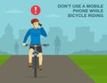 Do not use a mobile phone while bicycle riding. Front view of a cyclist talking on phone while cycling on city road.
