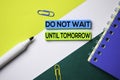 Do Not Wait Until Tomorrow text on sticky notes with office desk concept