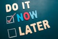 Do It Now or Later with checkbox and red check on blackboard Royalty Free Stock Photo