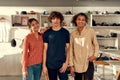 We do it right. Portrait of smiling workers looking at camera while standing in the office. Young man and two women Royalty Free Stock Photo