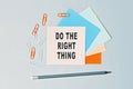 Do the right thing - text on sticky note paper on gray background. Closeup of a personal agenda. Top view Royalty Free Stock Photo