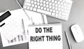 DO THE RIGHT THING text written on notebook on grey background with chart and keyboard, business concept Royalty Free Stock Photo