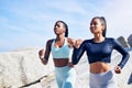 We do running dates as much as we do coffee ones. two fit young women out for a run along the beach. Royalty Free Stock Photo