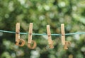 DO IT word written by hanged wooden letters on rope at garden