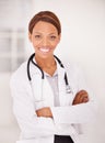 Do you have a good medical aid. A portrait of an ethnic female doctor with her arms folded and smiling at the camera. Royalty Free Stock Photo