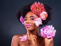 Do you know whats beautiful, you are. Studio shot of a beautiful young woman posing with flowers in her hair.