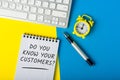 Do you know your customers - question in notepad at office workplace Royalty Free Stock Photo