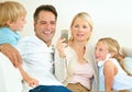 Do you remember this. a woman showing her husband her phone while their two children sit next to them. Royalty Free Stock Photo