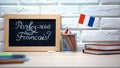 Do you speak French written on board, France flag standing in box, language Royalty Free Stock Photo