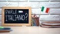 Do you speak Italian written on board, international flag in box, language Royalty Free Stock Photo