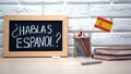 Do you speak Spanish written on board, international flag in box, language Royalty Free Stock Photo