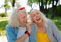 Joyful happy man offering a strawberry