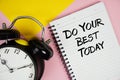 Do Your Best Today text written on notepad with alarm clock on pink background Royalty Free Stock Photo