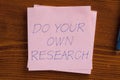 Do your own research written on a note Royalty Free Stock Photo