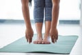 Do your stretches first and last. Closeup shot of an unrecognisable woman touching her toes while exercising in a yoga Royalty Free Stock Photo