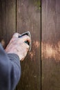 Do it yourself, closeup hand with a electric sander on wooden bo Royalty Free Stock Photo