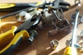 Do It Yourself DIY accessories - locksmith tools, wrenches, screwdrivers, pliers, nuts and bolts on a wooden table Royalty Free Stock Photo