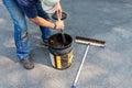 Driveway maintenance, stirring sealant before pouring