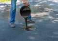 Pouring asphalt sealant on driveway