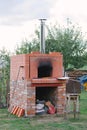 Do-it-yourself professional oven with open fire built in summer cottage for baking pizza Royalty Free Stock Photo