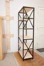 Do-it-yourself wooden structure. light bookcase with 6 six shelves in production in the wooden furniture manufactory. side view