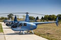 Line of Robinson helicopters parked on helidrom