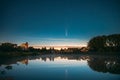 Dobrush, Belarus. Comet Neowise C2020f3 In Night Starry Sky Reflected In Small Lake Waters.