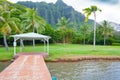 Dock on the beach with palm tree and pali mountains oahu hawaii Royalty Free Stock Photo