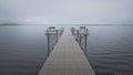 Dock with benches on foggy lake in Bemidji Minnesota Royalty Free Stock Photo