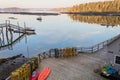 Dock and boats in bay in Boothbay, Maine, at sunrise in summer in soft beautiful light on reflective water