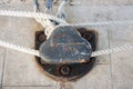 Dock bollard on stone pier with ship ropes Royalty Free Stock Photo